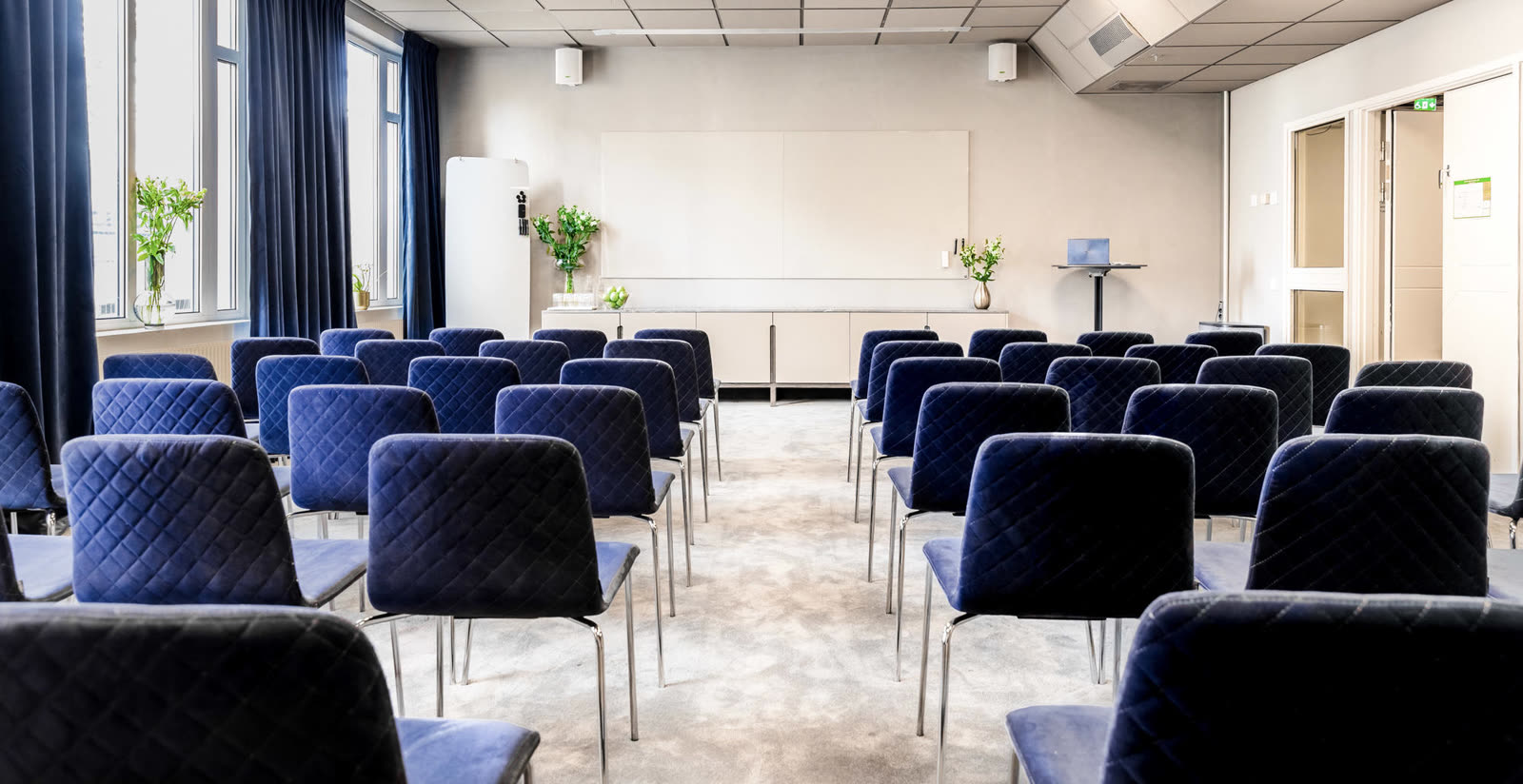 Conference room with blue velour chairs and carpet