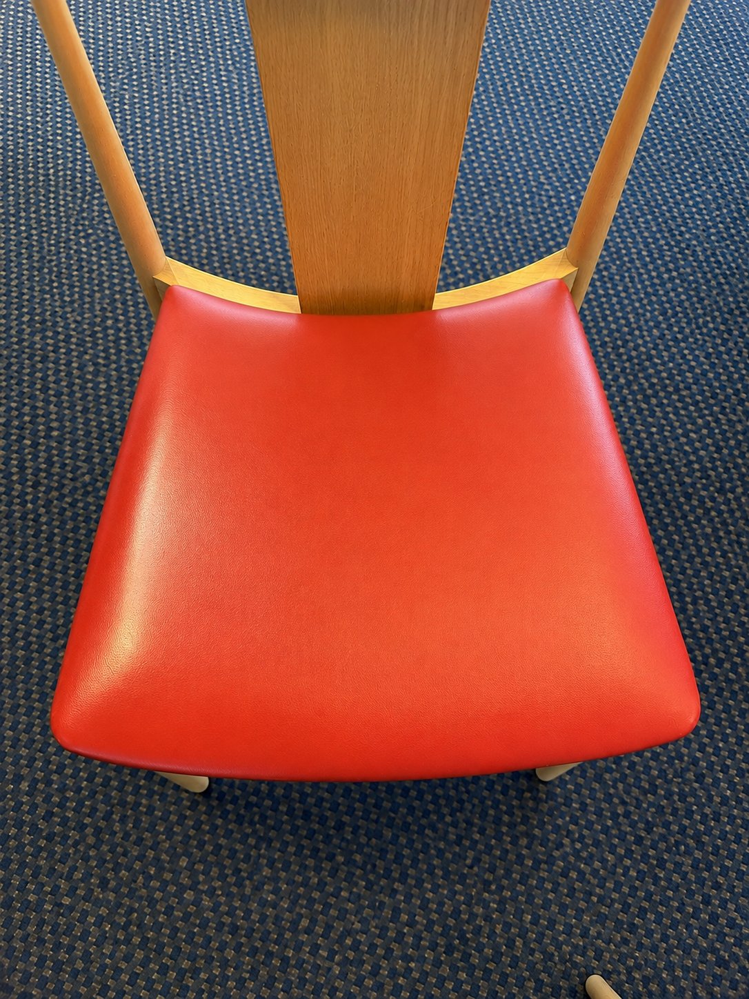 After treatment – clean and even red leather seat