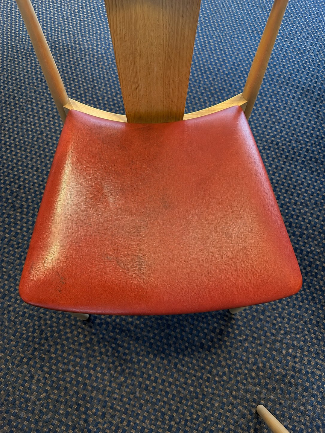 Before treatment – red leather seat with smudges and ingrained dirt