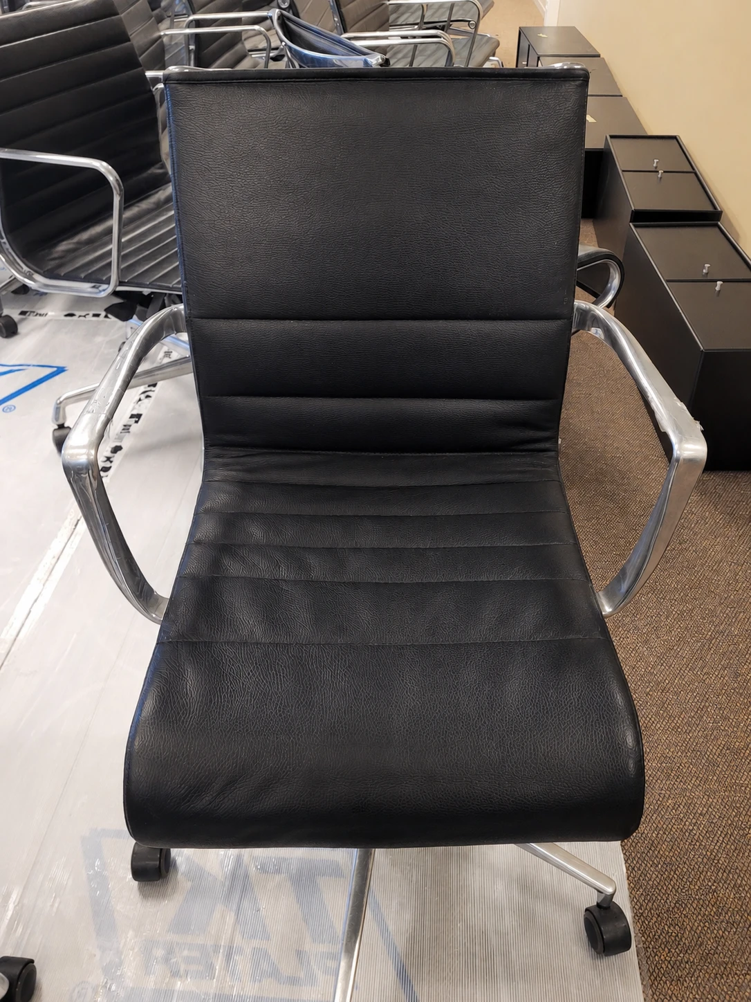 After treatment — restored black leather chair