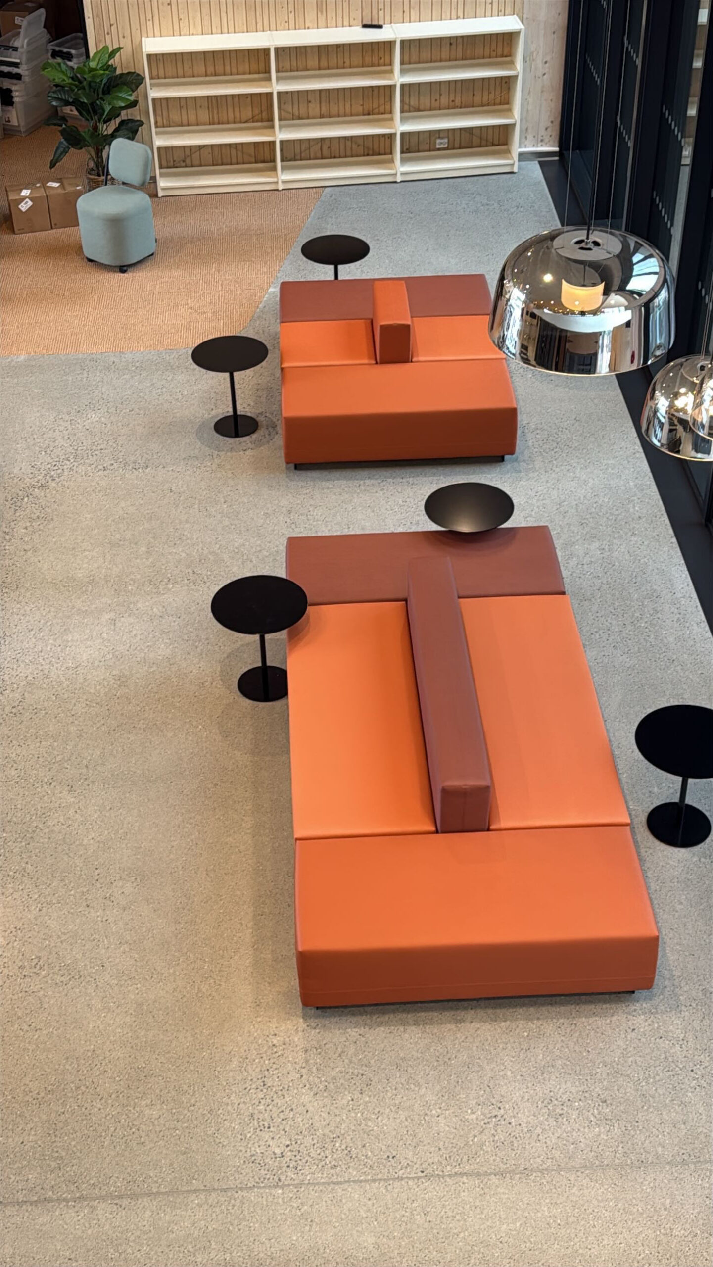School lounge area with orange modular sofas and carpet
