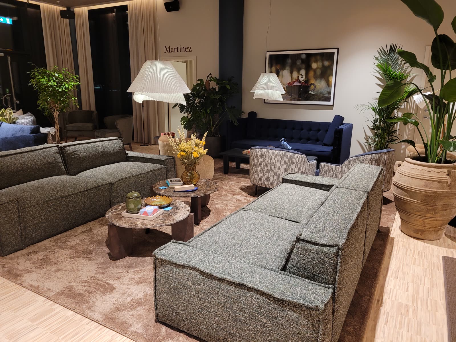 Suite lounge with navy velour sofa and boucle chairs