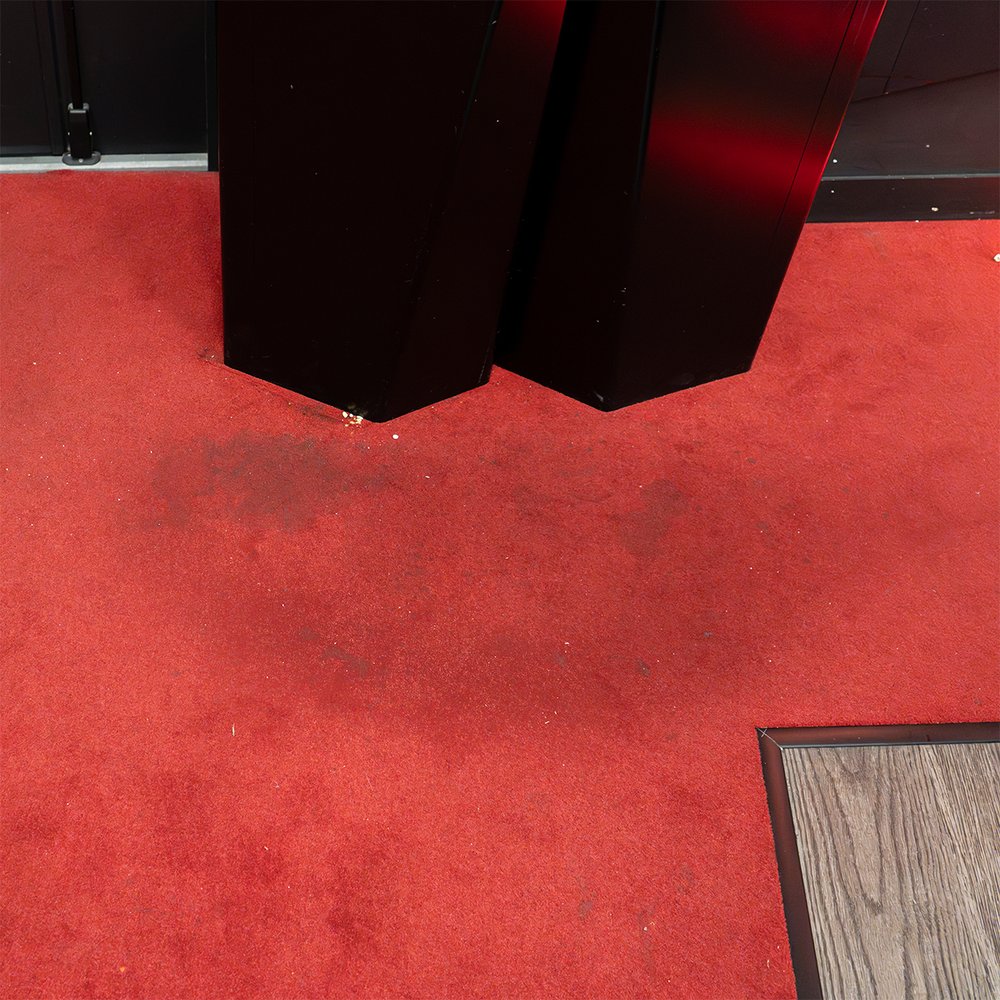 Before treatment – worn red cinema carpet